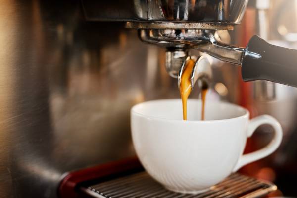 espresso-maker-pouring-coffee-into-mug
