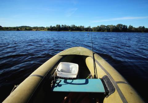 Front end of an inflatable kayak on the water