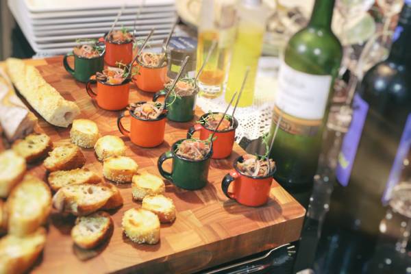 butchers block with hors d'oeuvres and open bottles of wine