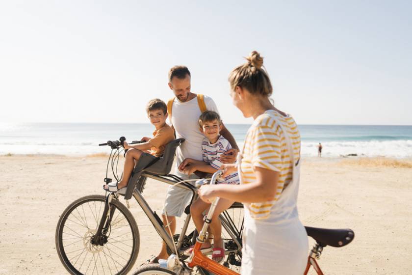 Family biking on the beach