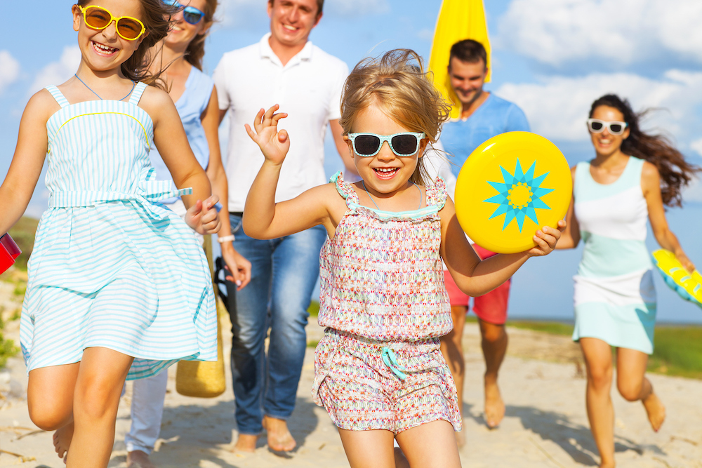 family walking to beach to play