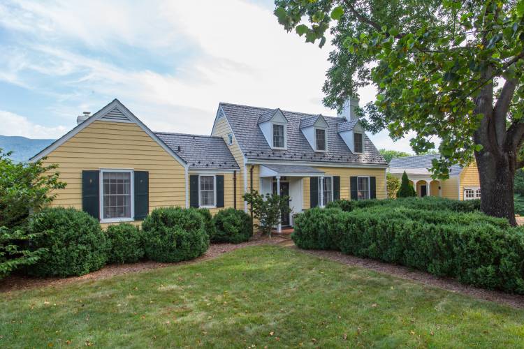 craftsman style yellow house with large front yard