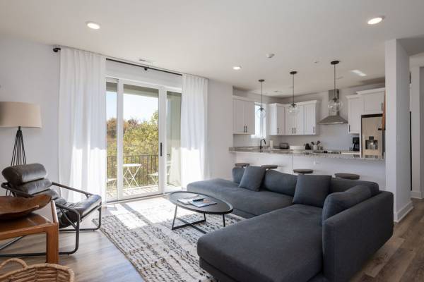 blue sectional couch in open concept living room and kitchen