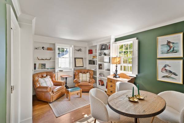 two large reading chairs in front of built-in shelves