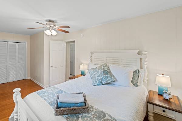 country style bed in bedroom with wooden floors