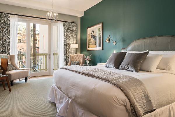 bedroom with green wall and balcony