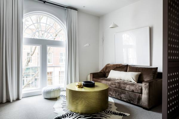 natural light enters a suite from arched doors