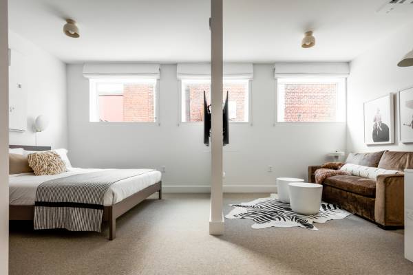 large bedroom suite with bed and couch facing each other
