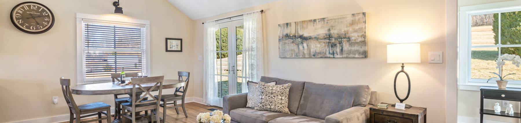 Living room with vaulted ceiling, couch, and table