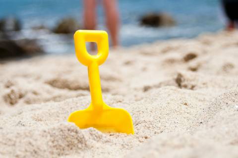 shovel in sand at beach