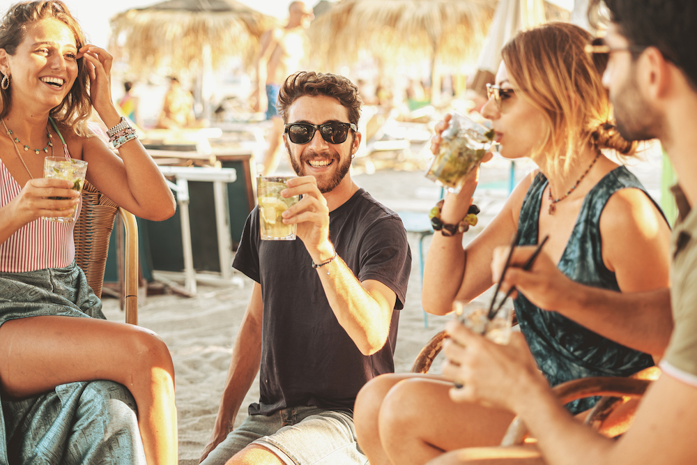 guy enjoying a cocktail at a beach bar