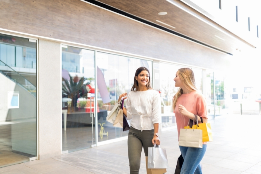 Two Women talk as they shop around Sanibel Outlets