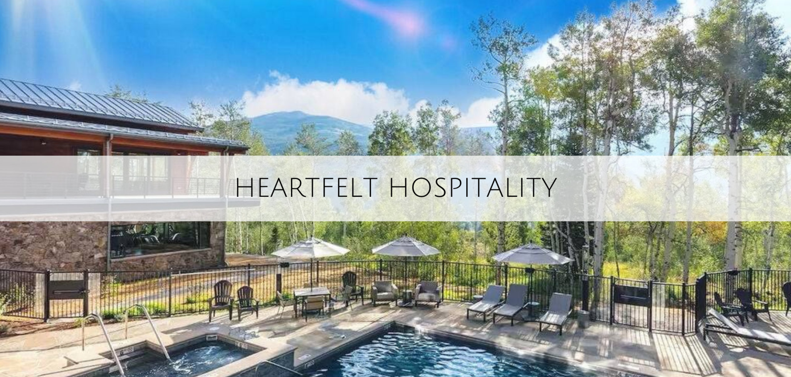 An outside shot of the pool and hot tub with a beautiful view of Summit Sky Ranch