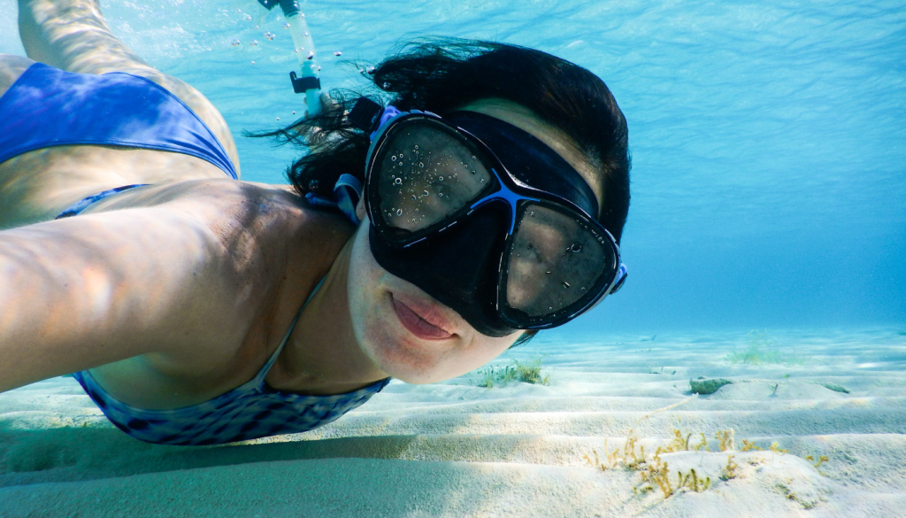 girl snorkeling underwater on the alabama gulf coast