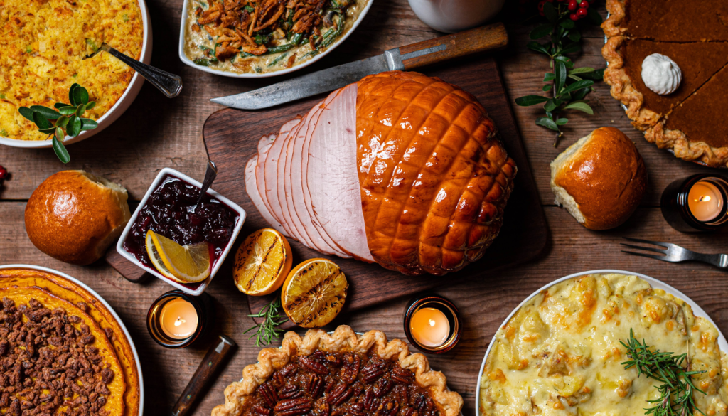 aerial image of thanksgiving feast including turkey, desserts, and sides