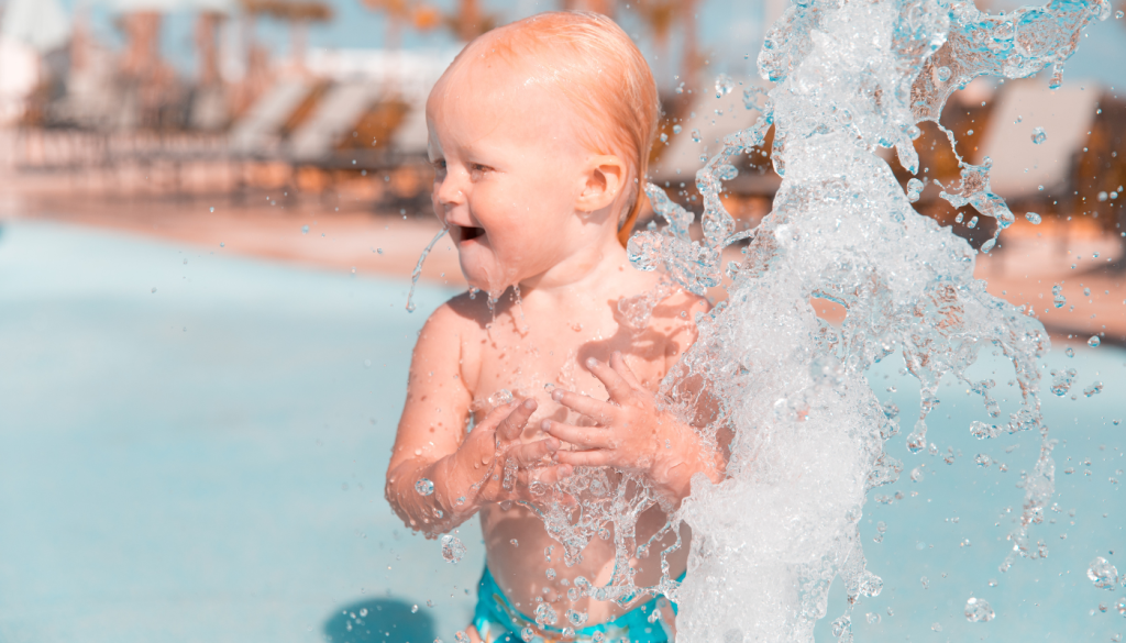 toddler playing in pool
