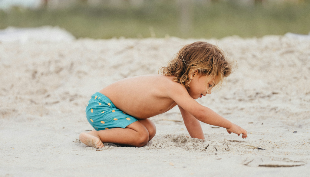 Boy playing in the sand in Orange Beach, AL