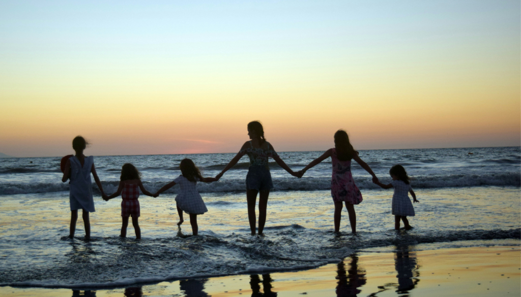 mom with daughters on beach in gulf shores
