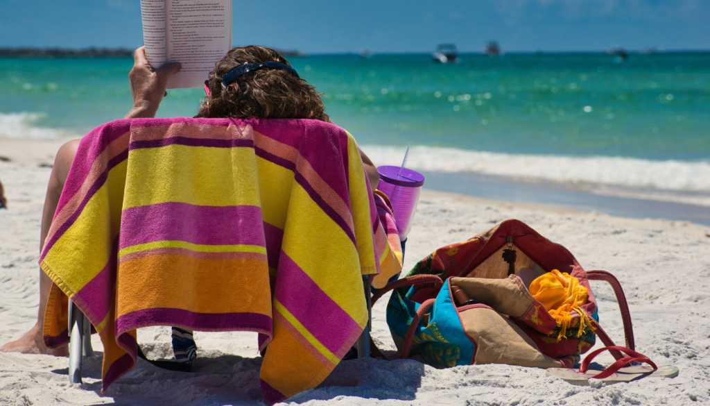 girl reading at a beach on the alabama gulf coast