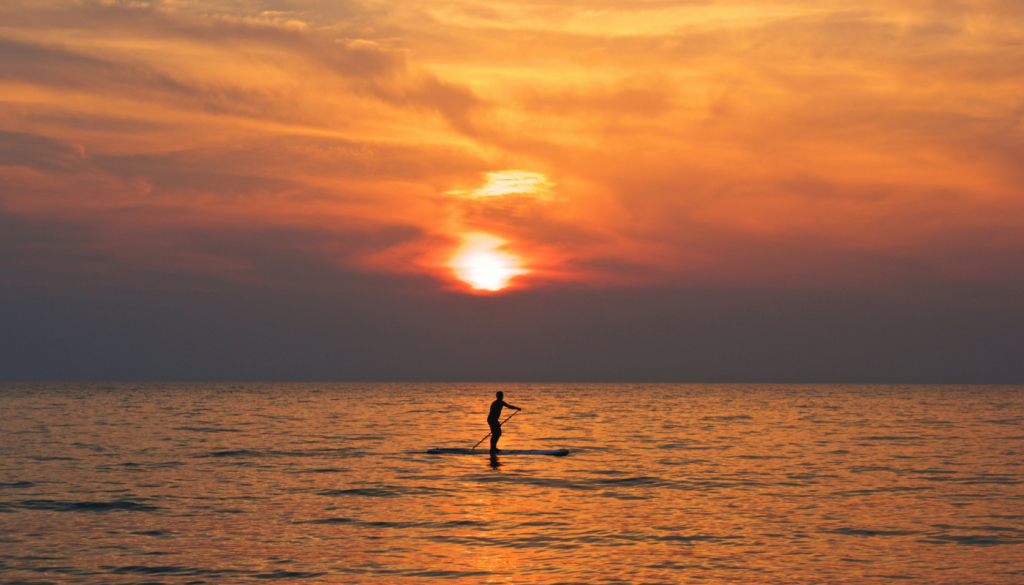 man paddleboarding on lake shelby in gulf shores, alabama