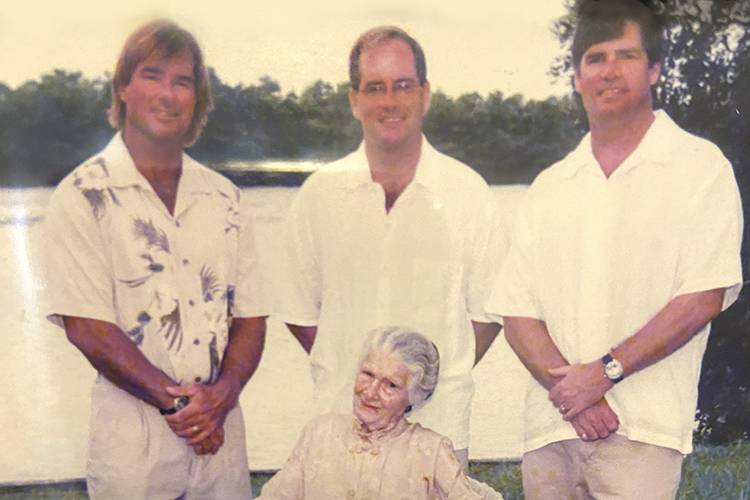 Bunga Barton sitting in front of her three grandsons in Sandbridge Virginia