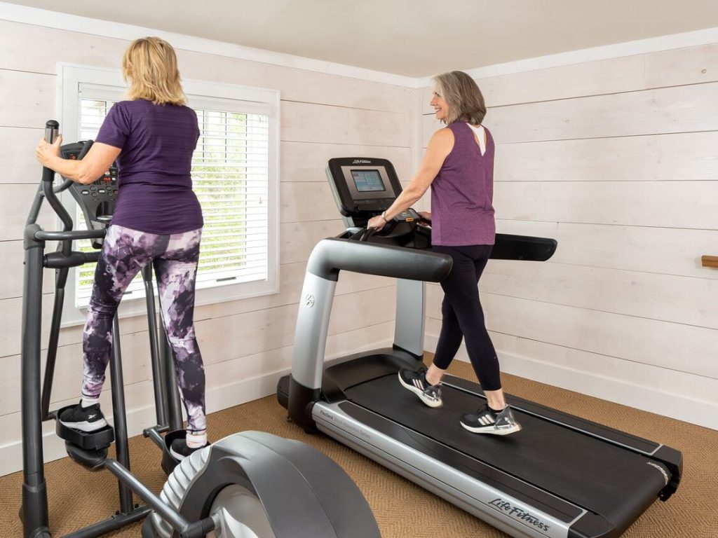 Gym with two people on equipment